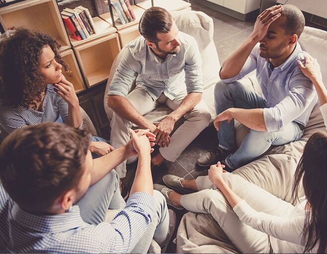group of people in recovery discussing how to maintain stress and external stimuli with techniques learned during therapy for addiction treatment